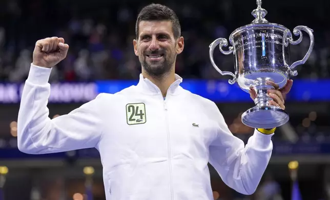 FILE - Novak Djokovic, of Serbia, holds up the championship trophy after defeating Daniil Medvedev, of Russia, in the men's singles final of the U.S. Open tennis championships, Sunday, Sept. 10, 2023, in New York. (AP Photo/Manu Fernandez, File)