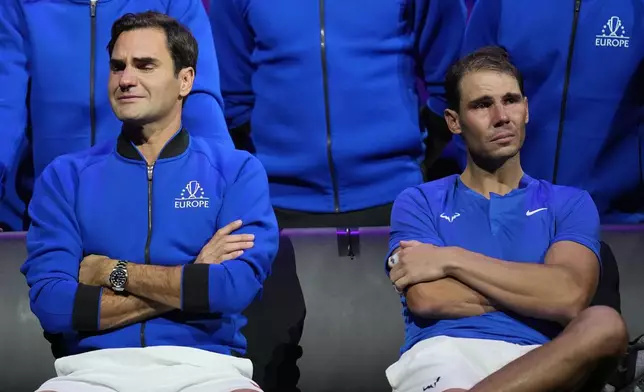 FILE - An emotional Roger Federer, left, of Team Europe, sits alongside his playing partner, Rafael Nadal, after their Laver Cup doubles match against Team World's Jack Sock and Frances Tiafoe at the O2 arena in London, Friday, Sept. 23, 2022. (AP Photo/Kin Cheung, File)