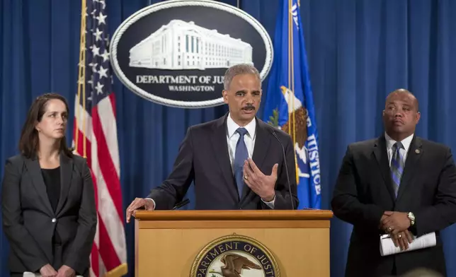 FILE - Attorney General Eric Holder, center, speaks during a news conference at the Justice Department in Washington, Thursday, Sept. 4, 2014, to announce the Justice Department's civil rights division will launch a broad civil rights investigation in the Ferguson, Mo., Police Department. Joining Holder are Molly Moran, left, Acting Assistant Attorney General for Civil Rights Division, and Ronald Davis, right, Dir. of the Office of Community Oriented Policing Services (COPS). (AP Photo/Pablo Martinez Monsivais, File)