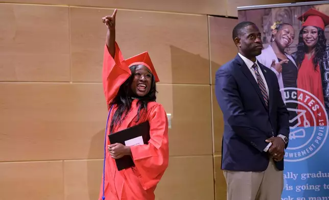 Shedreka Leblanc celebrating receiving a high school equivalency (HiSET) diploma at a graduation ceremony for the Youth Empowerment Project (YEP) in New Orleans, Thursday, June 27, 2024. (AP Photo/Matthew Hinton)