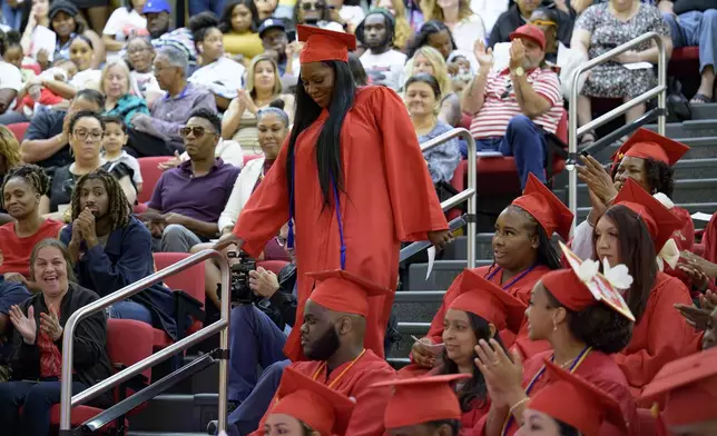 Sparkle Graham is recognized for her achievement during a high school equivalency (HiSET) diploma graduation ceremony for the Youth Empowerment Project (YEP) in New Orleans, Thursday, June 27, 2024. (AP Photo/Matthew Hinton)