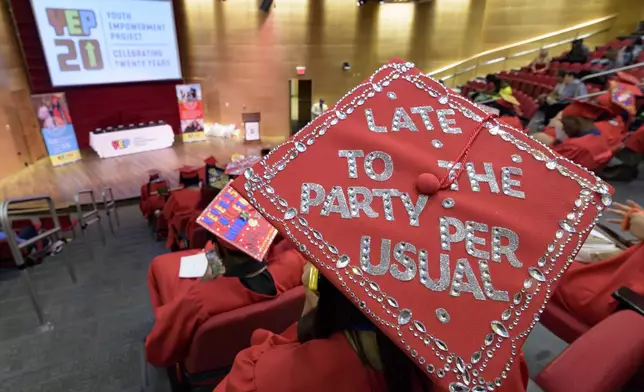 Mariah Middleton decorated her mortarboard graduate cap for a high school equivalency (HiSET) diploma graduation ceremony for the Youth Empowerment Project (YEP) in New Orleans, Thursday, June 27, 2024. (AP Photo/Matthew Hinton)