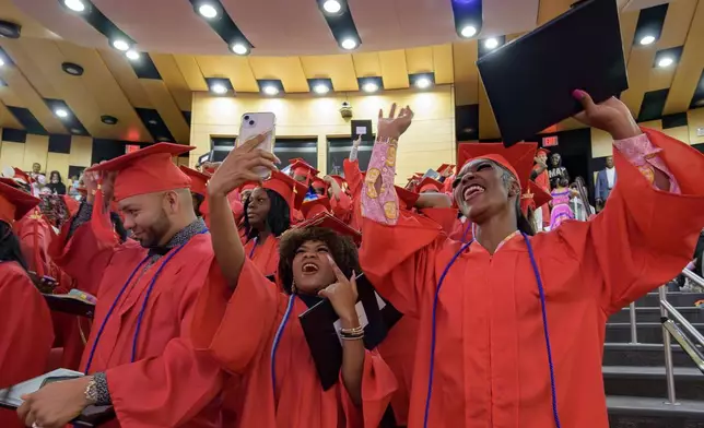 Keywanda Ashley, right, and Naomy Seiry Arzu Cruz, and Darwin Argueta, left, celebrate after receive their high school equivalency (HiSET) diplomas during a graduation ceremony for the Youth Empowerment Project (YEP) which received money from the NBA Foundation program in New Orleans, Thursday, June 27, 2024. (AP Photo/Matthew Hinton)