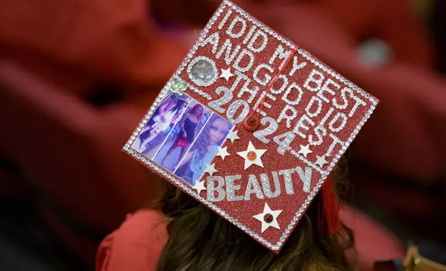 Joshanda Smith decorated her mortarboard graduate cap for a high school equivalency (HiSET) diploma graduation ceremony for the Youth Empowerment Project (YEP) in New Orleans, Thursday, June 27, 2024. (AP Photo/Matthew Hinton)