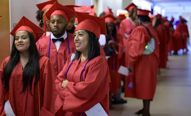 Graduates line up for their high school equivalency (HiSET) diplomas at a graduation ceremony for the Youth Empowerment Project (YEP), a non-profit organization which received money from the NBA Foundation program in New Orleans, Thursday, June 27, 2024. (AP Photo/Matthew Hinton)