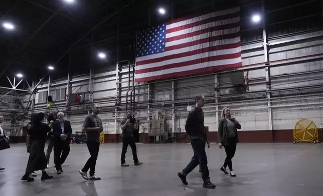 Reporter Evan Gershkovich, second from right, walks through a hangar at Kelly Field after he was released by Russia, Friday, Aug. 2, 2024, in San Antonio. (AP Photo/Eric Gay)