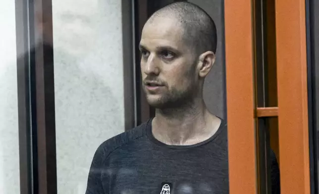 FILE - Wall Street Journal reporter Evan Gershkovich stands listening to the verdict in a glass cage of a courtroom inside the building of "Palace of justice," in Yekaterinburg, Russia, July 19, 2024. (AP Photo, File)