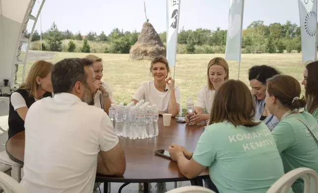 First lady Olena Zelenska talks to a teachers during her visit to the rehabilitation camp "Loud Camp" for children affected by war, organized by the Voices of Children Charitable Foundation and financially supported by the Olena Zelenska Foundation in Uzhhorod, Ukraine, Tuesday, Aug. 27, 2024. (AP Photo/Efrem Lukatsky)