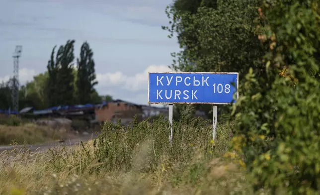 A plate with sign "Kursk 108 km" is seen on the Russian-Ukrainian border in Sumy region, Ukraine, Tuesday, Aug. 13, 2024. (AP Photo/Evgeniy Maloletka)