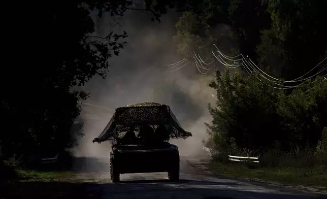 A Ukrainian armoured military vehicle travels near the Russian-Ukrainian border, Sumy region, Ukraine, Wednesday, Aug. 14, 2024. (AP Photo/Evgeniy Maloletka)