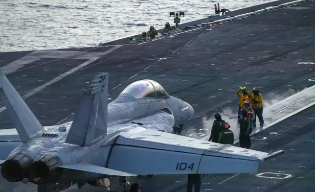 In this photograph released by the U.S. Navy, an F/A-18 Super Hornet prepares to launch off the flight deck of the Nimitz-class aircraft carrier USS Theodore Roosevelt July 5, 2024, in the South China Sea. (Seaman Aaron Haro Gonzalez/U.S. Navy via AP)