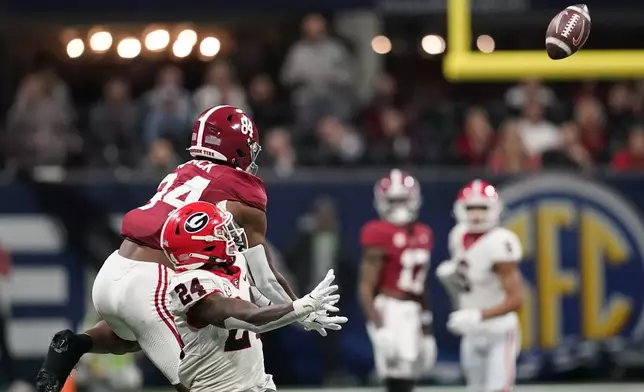 FILE - Alabama tight end Amari Niblack (84) and Georgia defensive back Malaki Starks (24) looks to catch the ball during the second half of the Southeastern Conference championship NCAA college football game in Atlanta, Saturday, Dec. 2, 2023. (AP Photo/Mike Stewart, File)