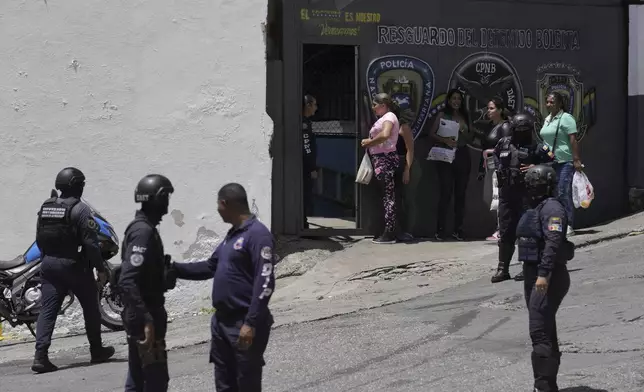 Detainees' relatives stand in line with food to give to their arrested family members, outside the Boleita National Police detention center after demonstrators were arrested in recent days during opposition protests against the official results of the presidential election in Caracas, Venezuela, Thursday, Aug. 1, 2024. (AP Photo/Matias Delacroix)