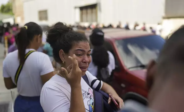 A resident who did not want to give her name gathers outside the Boleita National Police detention center after her brother was detained in recent days during opposition protests against the official results of the presidential election in Caracas, Venezuela, Thursday, Aug. 1, 2024. (AP Photo/Matias Delacroix)