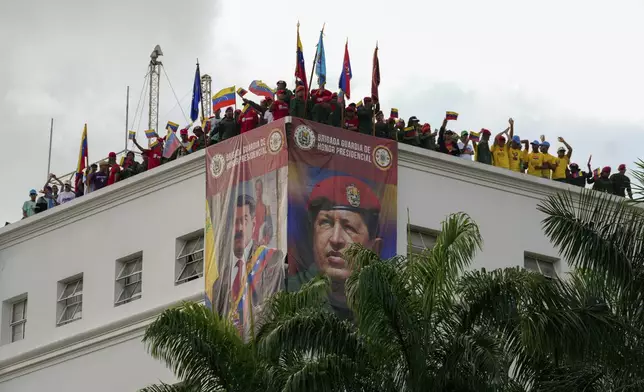 Members of the presidential guard listen to Venezuela's President Nicolas Maduro addressing government loyalists gathered at the presidential palace in support of his reelection one month after the presidential vote, in Caracas, Venezuela, Wednesday, Aug. 28, 2024. (AP Photo/Ariana Cubillos)