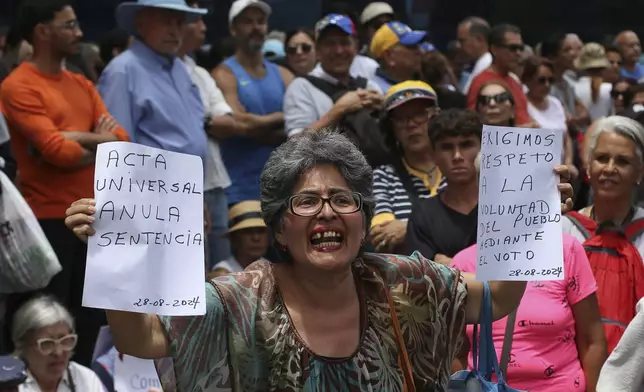 Opposition supporters protest the reelection of President Nicolás Maduro one month after the disputed vote, which opposition leaders claim they won by a landslide, in Caracas, Venezuela, Wednesday, Aug. 28, 2024. (AP Photo/Cristian Hernandez)