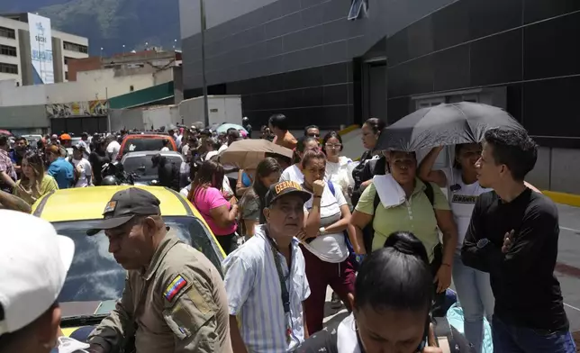 Detainees' families gather outside the Boleita National Police detention center after their relatives were arrested during recent opposition protests against the official results of the presidential election in Caracas, Venezuela, Thursday, Aug. 1, 2024. (AP Photo/Matias Delacroix)