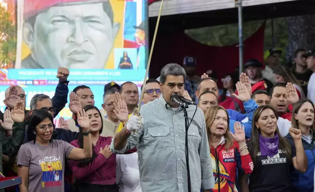 Venezuela's President Nicolás Maduro brandishes a sword as his new Cabinet takes the oath of office, at the presidential palace in Caracas, Venezuela, Wednesday, Aug. 28, 2024. (AP Photo/Ariana Cubillos)