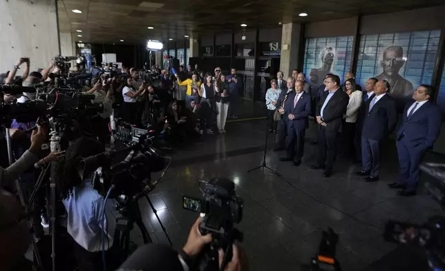 Opposition politicians Manuel Rosales, speaking, Jose Cartaya, left, and Simon Calzadilla, right, address the press outside the Supreme Court in Caracas, Venezuela, Wednesday, Aug. 7, 2024. The country's high court is conducting an audit of the disputed, July 28 presidential election. (AP Photo/Matias Delacroix)