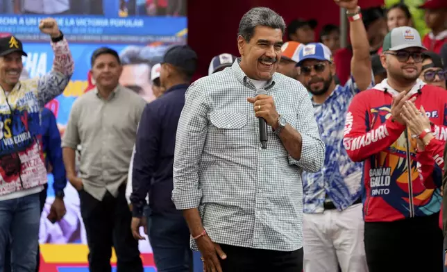 Venezuela's President Nicolas Maduro smiles while addressing government loyalists gathered at the presidential palace in support of his reelection one month after the presidential vote, in Caracas, Venezuela, Wednesday, Aug. 28, 2024. (AP Photo/Ariana Cubillos)