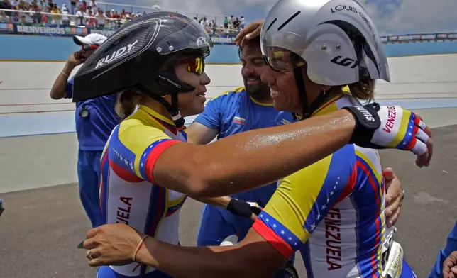 FILE - Venezuela's Daniela Larreal Chirinos, right, and Angie Gonzalez, celebrate their victory at the end of the women's team sprint final at the Central American and Caribbean Games in Mayaguez, Puerto Rico, July 24, 2010. Larreal Chirinos, a five-time Olympic cyclist who competed for Venezuela over the course of a decade, died on Aug. 15, 2024. She was 51. (AP Photo/Andres Leighton, File)