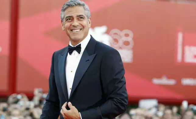 FILE - George Clooney poses on the red carpet at the premiere of his film "The Ides of March," opening the 68th edition of the Venice Film Festival in Venice, Italy on Aug. 31, 2011. (AP Photo/Andrew Medechini, File)