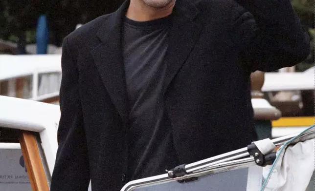 FILE - George Clooney arrives at the Lido for the Venice Film Festival in Venice, Italy, on Sept. 8, 1998, to promote the Steven Soderbergh film "Out Of Sight." (AP Photo/Francesco Proietti, File)