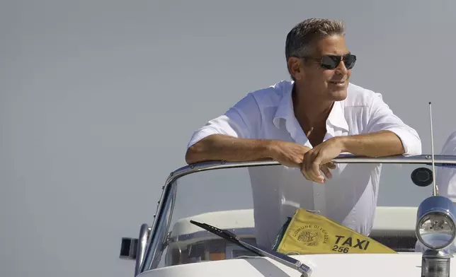 FILE - George Clooney arrives in Venice, Italy on a taxi boat for the 65th Venice Film Festival, Tuesday Aug. 26, 2008. (AP Photo/Joel Ryan, File)