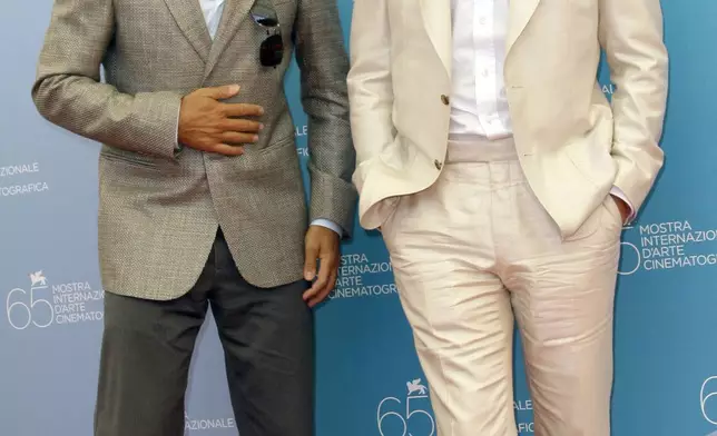 FILE - Actors George Clooney, left, and Brad Pitt appear at the photo call for their movie "Burn After Reading" at the 65th edition of the Venice Film Festival in Venice, Italy on Aug. 27, 2008. (AP Photo/Joel Ryan, File)