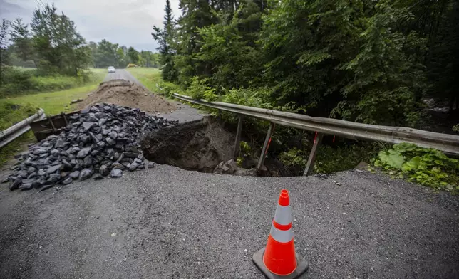 A cone blocks a washed out roadway in the aftermath of flash floods in Lyndonville, Vt., Wednesday, July 31, 2024. (AP Photo/Dmitry Belyakov)