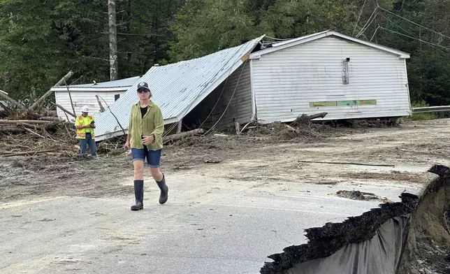 People clean up damage from flash floods in Lyndonville, Vt., Wednesday, July 31, 2024. Parts of the state hit by flooding Monday night and Tuesday are bracing again as a new round of severe thunderstorms moves through the region. (AP Photo/Nick Perry)