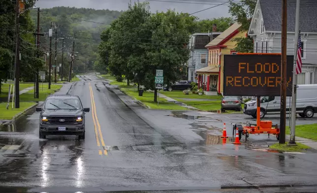 Water floods a roadway amid storms in Lyndon, Vt., Wednesday, July 31, 2024. (AP Photo/Dmitry Belyakov)