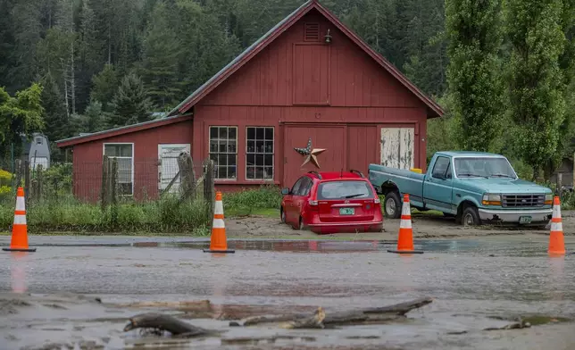 Damaged vehicles sit beside a farm in the aftermath of flash floods in Lyndon, Vt., Wednesday, July 31, 2024. (AP Photo/Dmitry Belyakov)