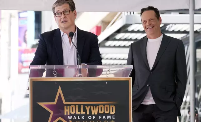 Actor Vince Vaughn, right, reacts as guest speaker Bill Lawrence, creator of the new Apple TV+ series "Bad Monkey," makes remarks during a ceremony to award Vaughn a star on the Hollywood Walk of Fame, Monday, Aug. 12, 2024, in Los Angeles. (AP Photo/Chris Pizzello)