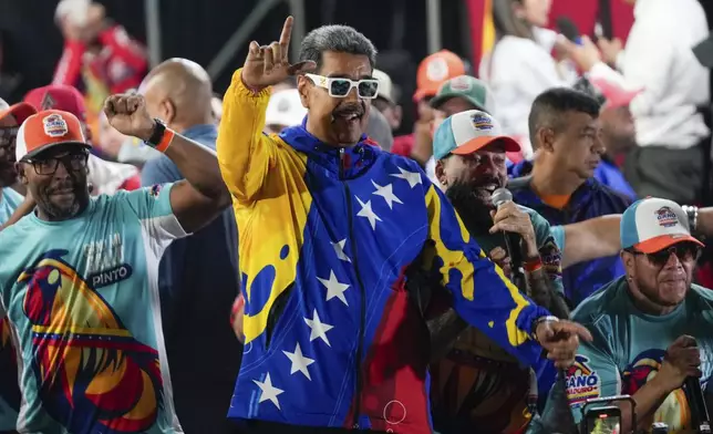 President Nicolas Maduro dances outside the Miraflores presidential palace after electoral authorities declared him the winner of the presidential election in Caracas, Venezuela, Monday, July 29, 2024. (AP Photo/Fernando Vergara)