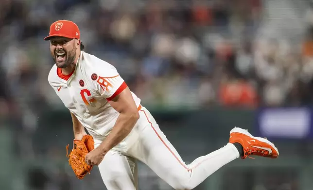 San Francisco Giants pitcher Robbie Ray reacts after throwing during the seventh inning of a baseball game against the Chicago White Sox in San Francisco, Tuesday, Aug. 20, 2024. (AP Photo/Nic Coury)