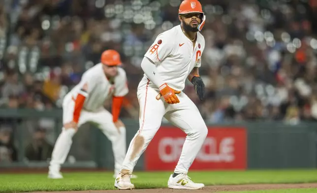 San Francisco Giants' Heliot Ramos leads off third base during the seventh inning of a baseball game against the Chicago White Sox in San Francisco, Tuesday, Aug. 20, 2024. (AP Photo/Nic Coury)