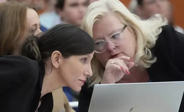 Kouri Richins, left, a Utah mother of three who wrote a children's book about coping with grief after her husband's death and was later accused of fatally poisoning him, speaks to her attorney, Kathy Nester, during a hearing Monday, Aug. 26, 2024, in Park City, Utah. (AP Photo/Rick Bowmer, Pool)