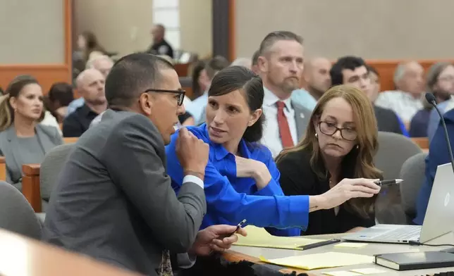 Kouri Richins, center, a Utah mother of three who wrote a children's book about coping with grief after her husband's death and was later accused of fatally poisoning him, looks on during a court hearing Tuesday, Aug. 27, 2024, in Park City, Utah. (AP Photo/Rick Bowmer, Pool)