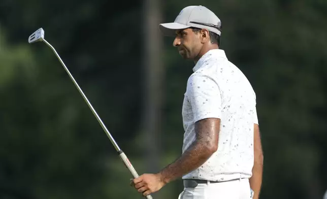 Aaron Rai, of England, reacts to his putt on the ninth hole during the final round of the Wyndham Championship golf tournament in Greensboro, N.C., Sunday, Aug. 11, 2024. (AP Photo/Chuck Burton)