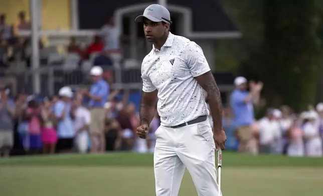 Aaron Rai, of England, celebrates on the 18th hole after winning the Wyndham Championship golf tournament in Greensboro, N.C., Sunday, Aug. 11, 2024. (AP Photo/Chuck Burton)