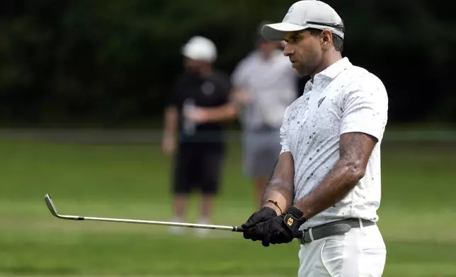 Aaron Rai, of England, watches his chip shot on the first hole during the final round of the Wyndham Championship golf tournament in Greensboro, N.C., Sunday, Aug. 11, 2024. (AP Photo/Chuck Burton)