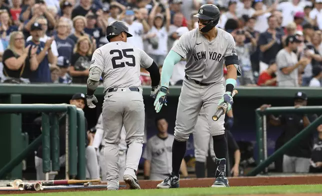 New York Yankees' Gleyber Torres (25) celebrates after his home run with Aaron Judge, right, during the first inning of a baseball game against the Washington Nationals, Monday, Aug. 26, 2024, in Washington. (AP Photo/Nick Wass)