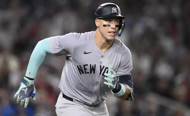 New York Yankees' Aaron Judge runs to first base on his single during the ninth inning of a baseball game against the Washington Nationals, Monday, Aug. 26, 2024, in Washington. (AP Photo/Nick Wass)