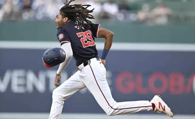 Washington Nationals' James Wood steals second base during the first inning of a baseball game against the New York Yankees, Tuesday, Aug. 27, 2024, in Washington. (AP Photo/John McDonnell)