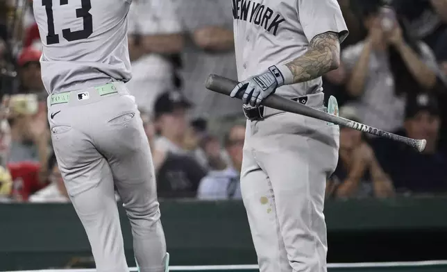 New York Yankees' Jazz Chisholm Jr. (13) celebrates his home run with Alex Verdugo, right, during the eighth inning of a baseball game against the Washington Nationals, Monday, Aug. 26, 2024, in Washington. (AP Photo/Nick Wass)