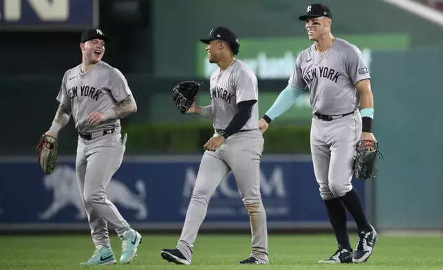 New York Yankees' Alex Verdugo, left, Juan Soto, center, and Aaron Judge, right, celebrate after a baseball game against the Washington Nationals, Monday, Aug. 26, 2024, in Washington. (AP Photo/Nick Wass)