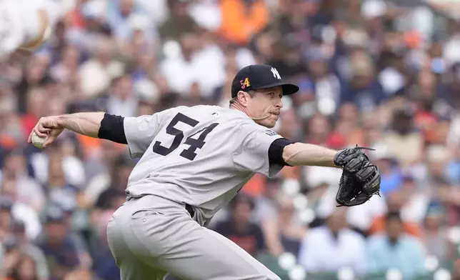 New York Yankees pitcher Tim Hill throws to first during eighth inning of a baseball game against the Detroit Tigers, Saturday, Aug. 17, 2024, in Detroit. (AP Photo/Carlos Osorio)