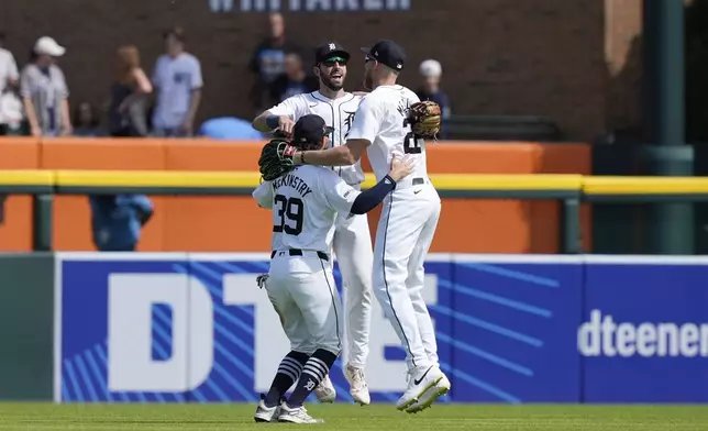 Detroit Tigers right fielder Zach McKinstry (39), center fielder Parker Meadows (22) and left fielder Matt Vierling celebrate after the ninth inning of a baseball game against the New York Yankees, Saturday, Aug. 17, 2024, in Detroit. (AP Photo/Carlos Osorio)