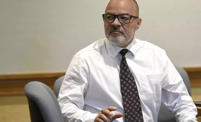 Victor Malavet looks behind him and waves to a person in the gallery during his trial at Merrimack County Superior Court in Concord, N.H., on Monday, Aug. 26, 2024. Malavet, a former state employee is charged in connection with the attorney general's probe of the Sununu Youth Services Center in Manchester. (David Lane/Union Leader via AP, Pool)